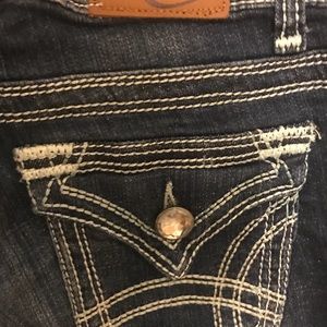 Bootcut jeans with flap pockets and crystal button